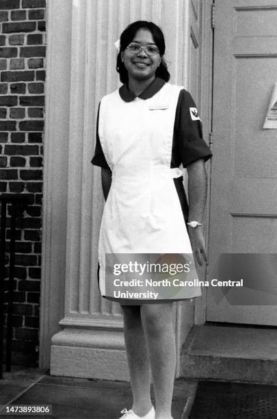 Smiling nursing student standing in uniform.
