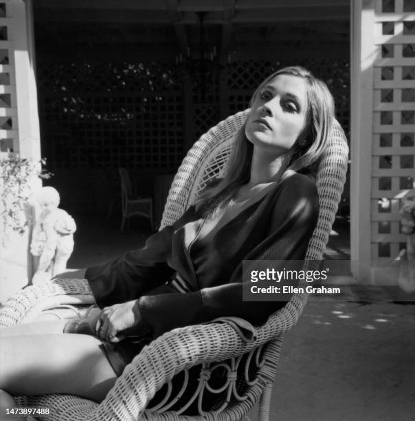 Portrait of American fashion model and actor Sharon Tate sitting in a chair outside, Beverly Hills, California, 1968.