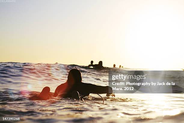 man on surfer paddle - surfers in the sea at sunset bildbanksfoton och bilder