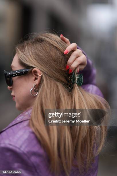 Sonia Lyson seen wearing Carolina Herrera black / green sparkling sunglasses, Rotate purple lilac long crocodile pattern leather coat, silver...