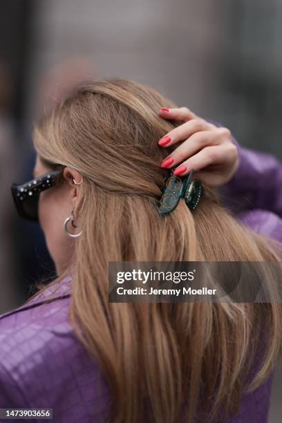 Sonia Lyson seen wearing Carolina Herrera black / green sparkling sunglasses, Rotate purple lilac long crocodile pattern leather coat, silver...