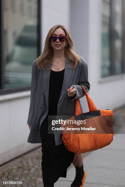 Sonia Lyson seen wearing Louis Vuitton pink sunglasses, silver earrings, The Mother Set black long maxi dress, The Frankie Shop grey striped blazer...