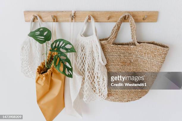 eco friendly bags hanging on coat hook - coat stand stock pictures, royalty-free photos & images