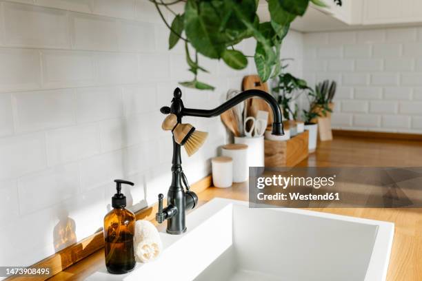 white sink in kitchen counter at home - soap dispenser stock pictures, royalty-free photos & images