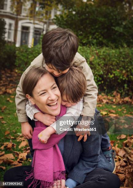 cheerful aunt enjoying with nephews at park - nephew stock pictures, royalty-free photos & images