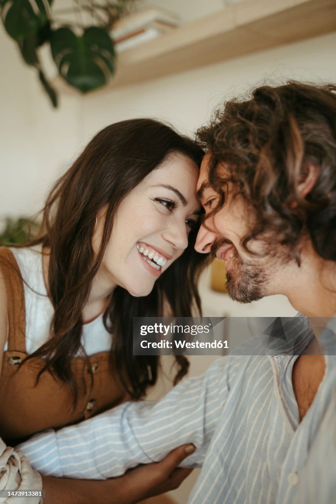 Happy Affectionate Couple Touching Foreheads At Home High-Res Stock ...