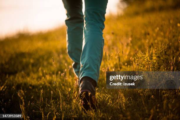 woman hiking outdoors in nature at sunset - bronze boot stock pictures, royalty-free photos & images