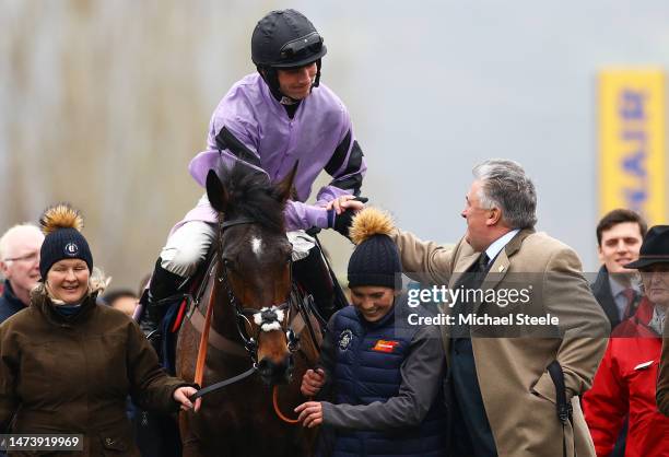 Trainer Paul Nicholls celebrates alongside Harry Cobden on board Stage Star after winning the Turners Novices Chase during day three of the...