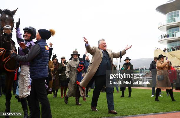 Trainer Paul Nicholls celebrates alongside Harry Cobden on board Stage Star after winning the Turners Novices Chase during day three of the...