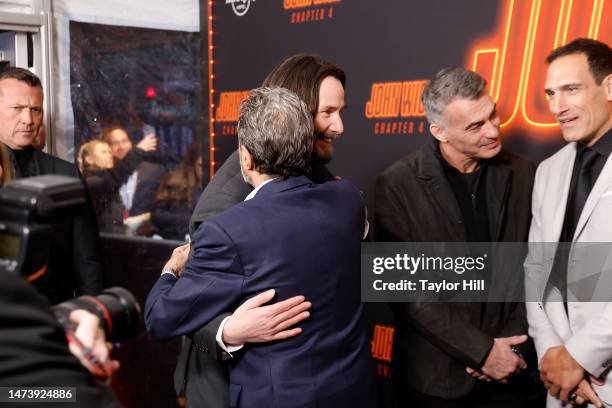 Keanu Reeves greets Ian McShane at the New York screening of "John Wick: Chapter 4" at AMC Lincoln Square Theater on March 15, 2023 in New York City.
