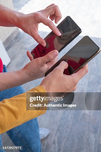 Detail Of Hands Of Two Women Using Their Mobile Phones For Digital ...