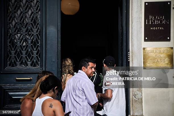 People wait in line by the door the Brazilian consulate in Lisbon on June 28, 2012. The OECD 2012 report on immigration revealed that more than...