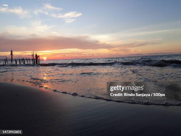 scenic view of beach against sky during sunset,indonesia - rindo stock-fotos und bilder