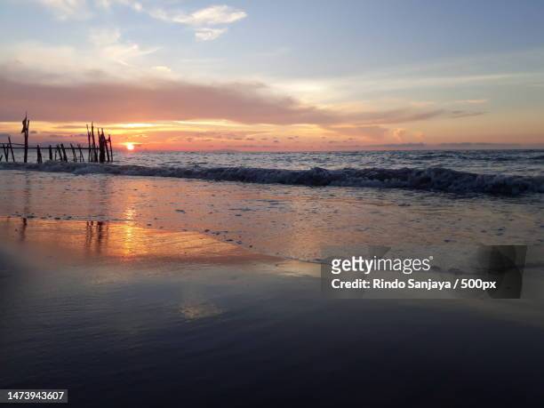 scenic view of beach against sky during sunset,indonesia - rindo stock-fotos und bilder