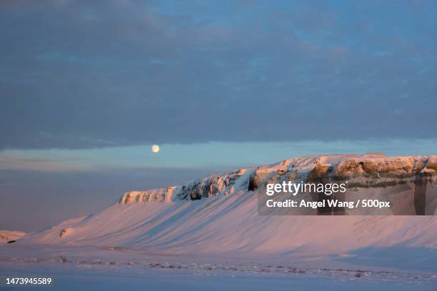 scenic view of snowcapped mountains against sky at night,iceland - angel island stock-fotos und bilder