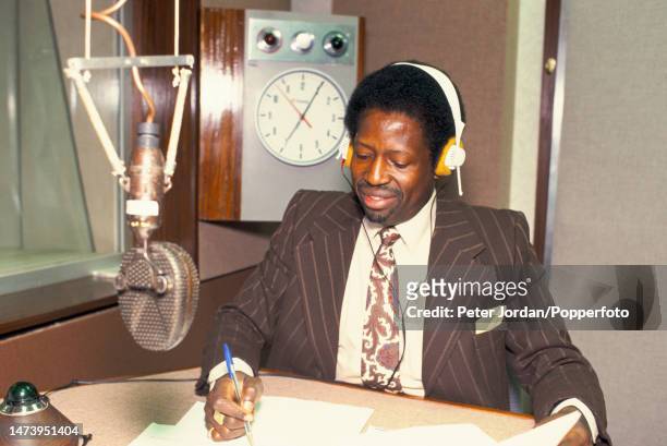 Presenter Hilton Fyle of the Africa Section broadcasts from the news desk in a radio studio at Bush House, headquarters of the BBC World Service...
