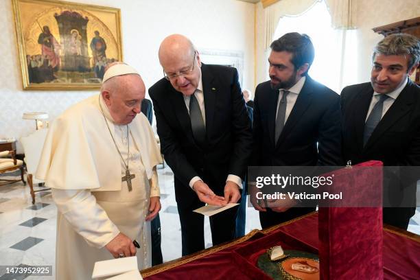 Pope Francis exchanges gifts with Prime Minister of Lebanon Najib Azmi Mikati during an audience at his private library of the Apostolic Palace on...