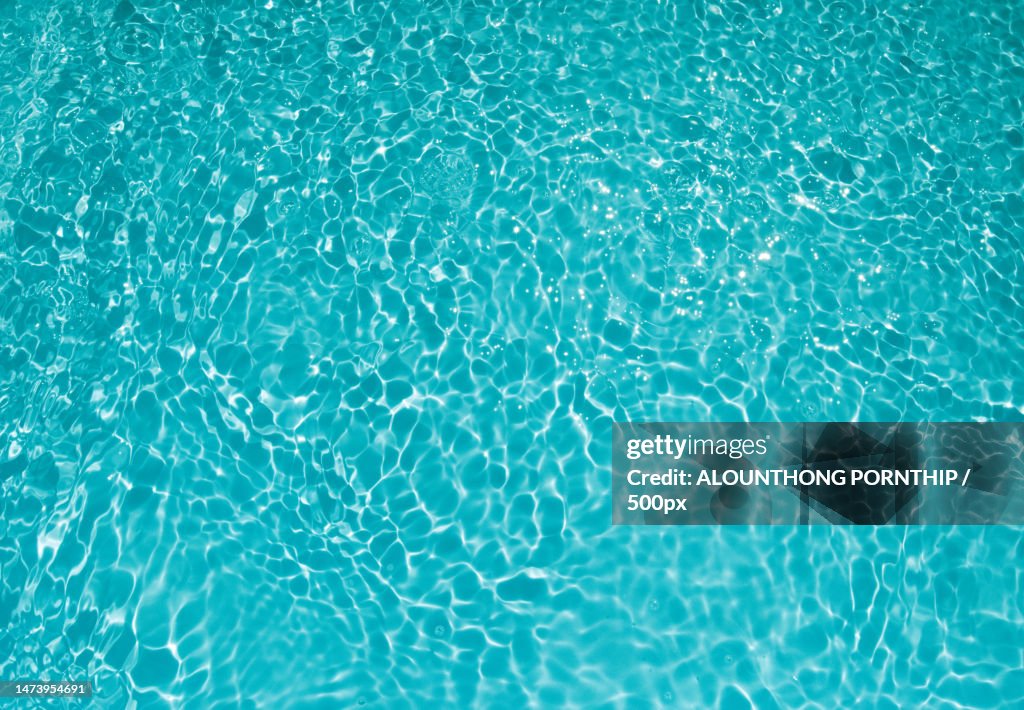 Defocus blurred transparent blue colored clear calm water surface texture with splashes and bubbles,Laos