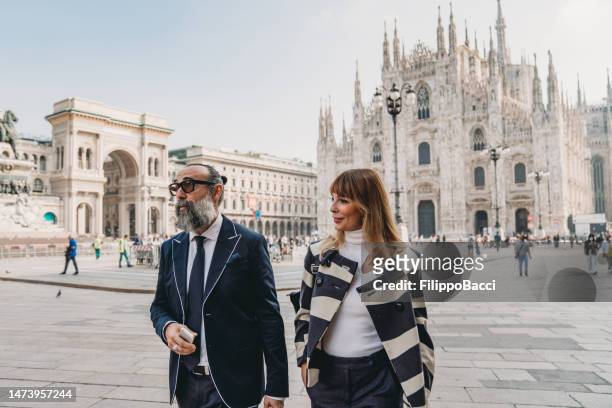 business people are walking in the city - piazza del duomo, milan - milan business stock pictures, royalty-free photos & images