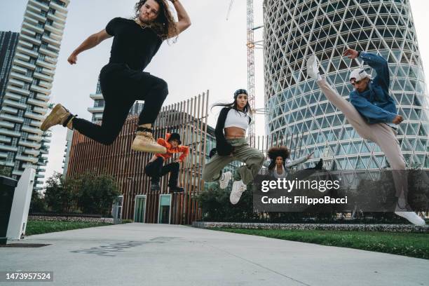 five cool friends are jumping in a modern location - hip hopper stock pictures, royalty-free photos & images