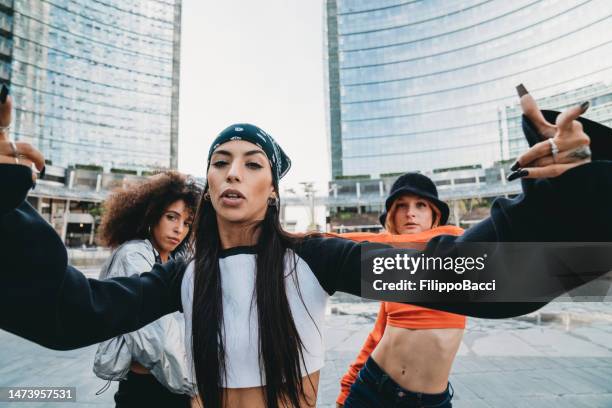 three female dancer friends are posing in a modern city - three people dancing stock pictures, royalty-free photos & images