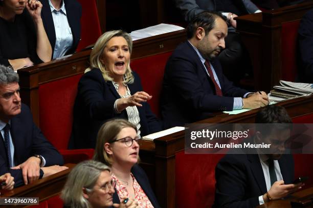 Marine Le Pen leader of the extreme right party "Rassemblement National" reacts as French Prime Minister Elisabeth Borne addresses deputies to...