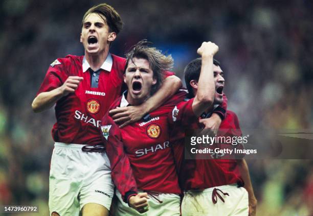 Manchester United players Gary Neville and Roy Keane celebrate a goal with David Beckham during a 2-1win over West Ham United at Old Trafford on...