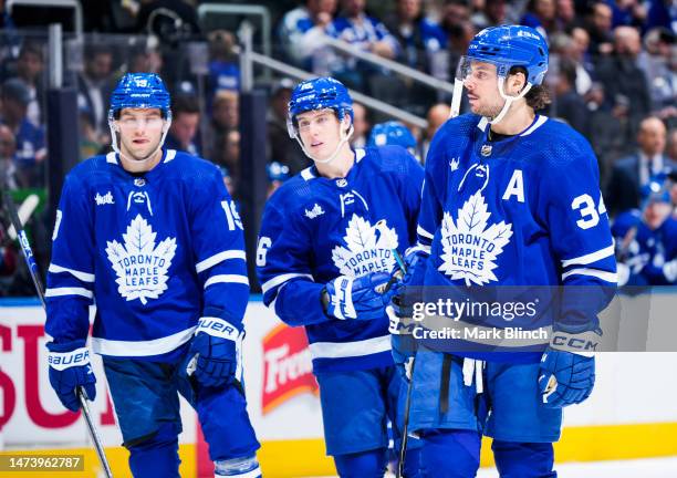 Auston Matthews, Mitch Marner and Calle Jarnkrok of the Toronto Maple Leafs look on against the Colorado Avalanche during the second period at the...