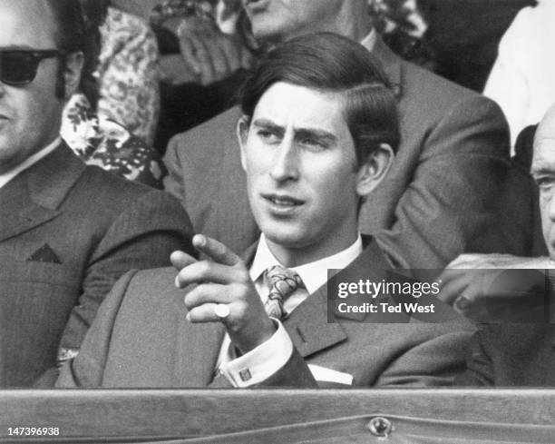 Prince Charles watching a match between Dennis Ralston and John Newcombe, on the Centre Court during the Wimbledon Lawn Tennis Championships, London,...