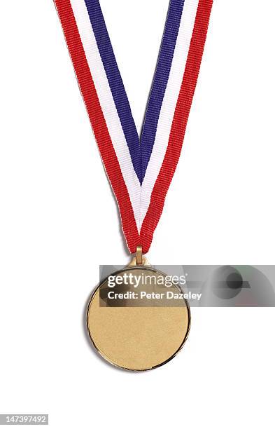 a medal on a striped ribbon, on a white background - gold medal fotografías e imágenes de stock