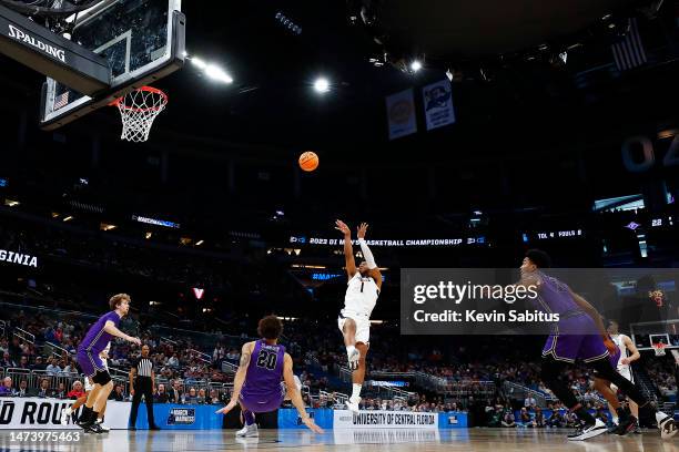 Jayden Gardner of the Virginia Cavaliers shoots the ball against Jalen Slawson of the Furman Paladins during the first half in the first round of the...