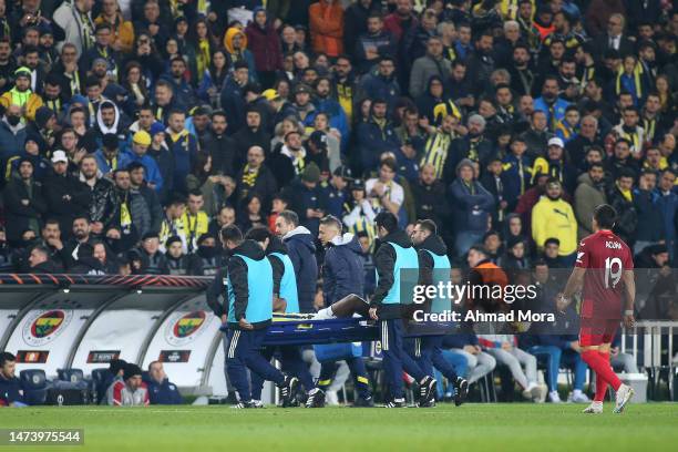 Michy Batshuayi of Fenerbahce leaves the pitch on a stretcher after picking up an injury during the UEFA Europa League round of 16 leg two match...