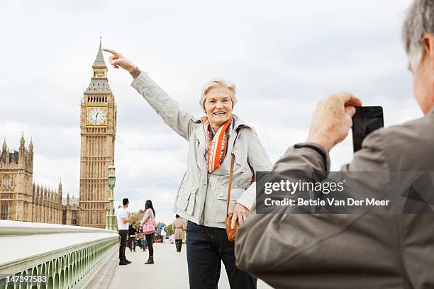 mature couple in front of big ben. - london travel stock-fotos und bilder