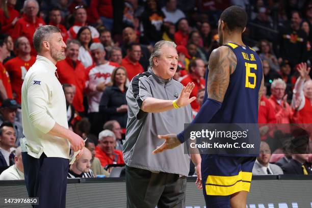 Head coach Bob Huggins of the West Virginia Mountaineers speaks to Jimmy Bell Jr. #15 during the second half against the Maryland Terrapins in the...