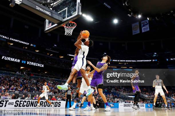 Reece Beekman of the Virginia Cavaliers drives to the basket against Furman Paladins during the first half in the first round of the NCAA Men's...