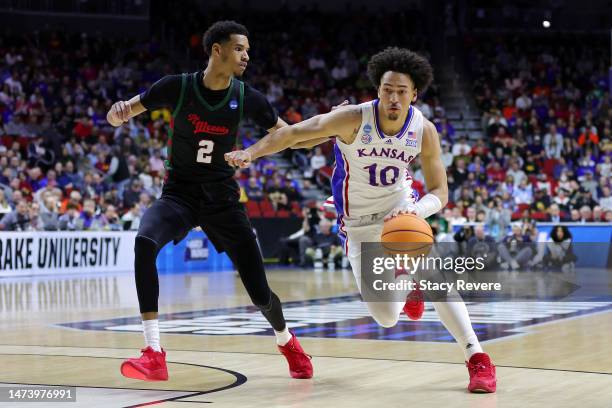 Jalen Wilson of the Kansas Jayhawks drives to the basket whilst under pressure from Steve Settle III of the Howard Bison during the first half in the...
