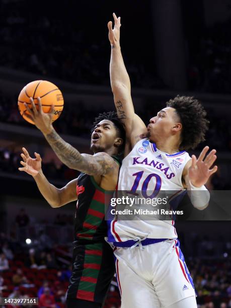 Elijah Hawkins of the Howard Bison goes for a lay up against Jalen Wilson of the Kansas Jayhawks during the first half in the first round of the NCAA...