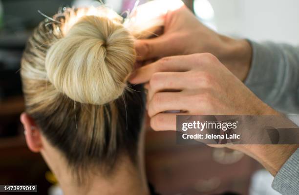 hairdresser stabs hair with hairpin - hair pin stock pictures, royalty-free photos & images