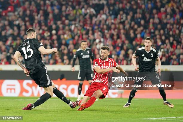 Federico Gatti of Juventus shoots under pressure from Manuel Gulde of Sport-Club Freiburg during the UEFA Europa League round of 16 leg two match...