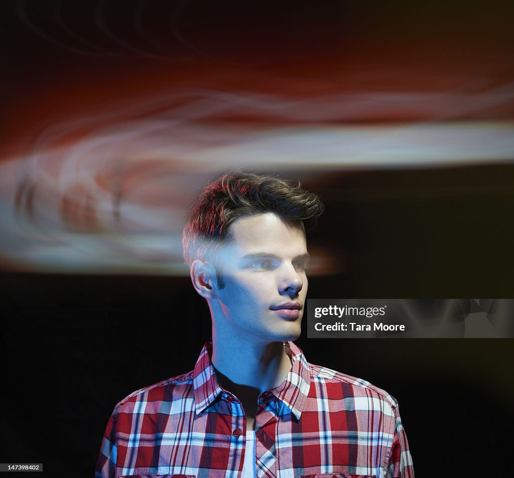 Man looking through light trails