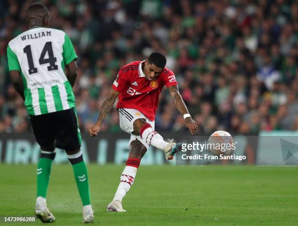 Marcus Rashford of Manchester United scores the team's first goal under pressure from William Carvalho of Real Betis during the UEFA Europa League...
