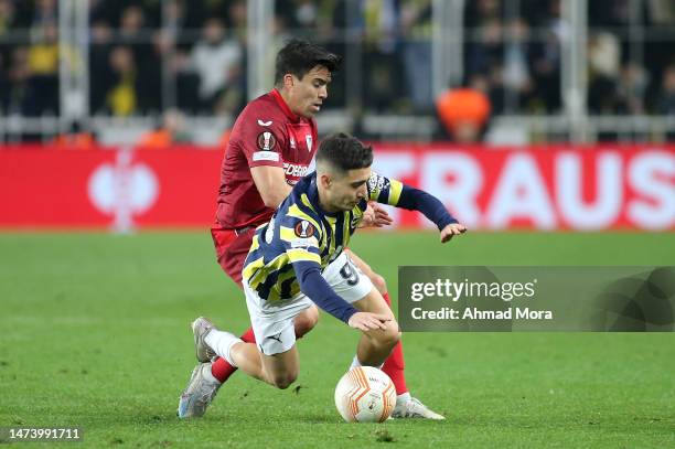 Emre Mor of Fenerbahce battles for possession with Marcos Acuna of Sevilla FC during the UEFA Europa League round of 16 leg two match between...