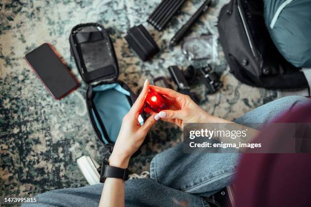 woman is holding a bicycle light - bicycle light stock pictures, royalty-free photos & images