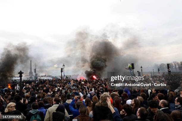 Protesters gather during a demonstration at Place de la Concorde, in front of the French National Assembly, after the French government bypass...