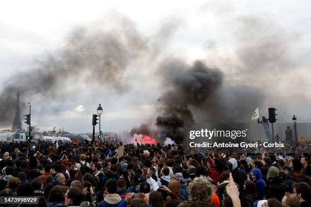 Protesters gather during a demonstration at Place de la Concorde, in front of the French National Assembly, after the French government bypass...