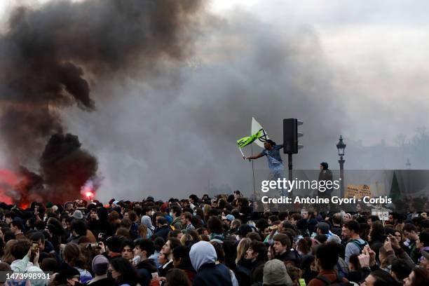 Protesters gather during a demonstration at Place de la Concorde, in front of the French National Assembly, after the French government bypass...