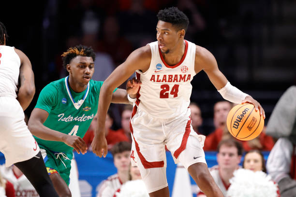 Brandon Miller of the Alabama Crimson Tide dribbles the ball against Jalen Jackson of the Texas A&M-CC Islanders during the second half in the first...