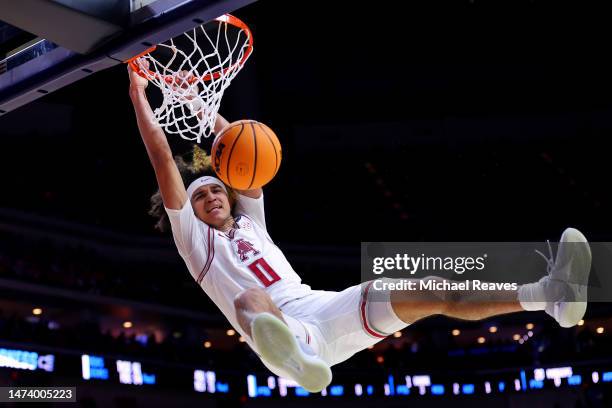 Anthony Black of the Arkansas Razorbacks dunks the ball whilst under pressure from Coleman Hawkins of the Illinois Fighting Illini during the first...