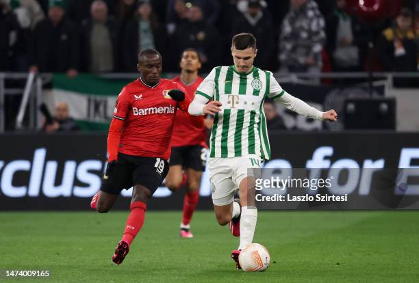 Amer Gojak of Ferencvarosi TC battles for possession with Noah Mbamba of Bayer 04 Leverkusen during the UEFA Europa League round of 16 leg two match...
