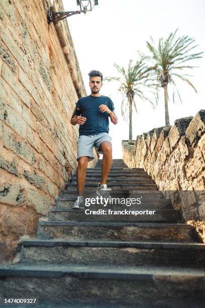 sport man descending the stairs - low motivation stock pictures, royalty-free photos & images